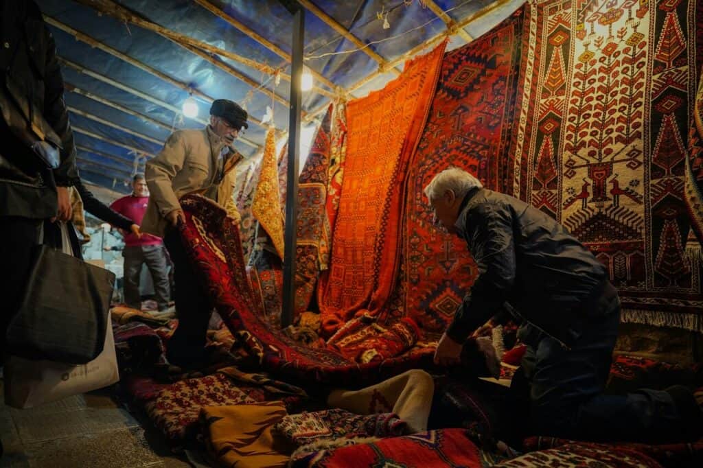 Tourist examining carpets