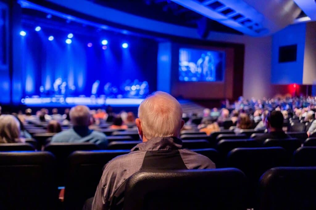 Tourists seated in a theater 