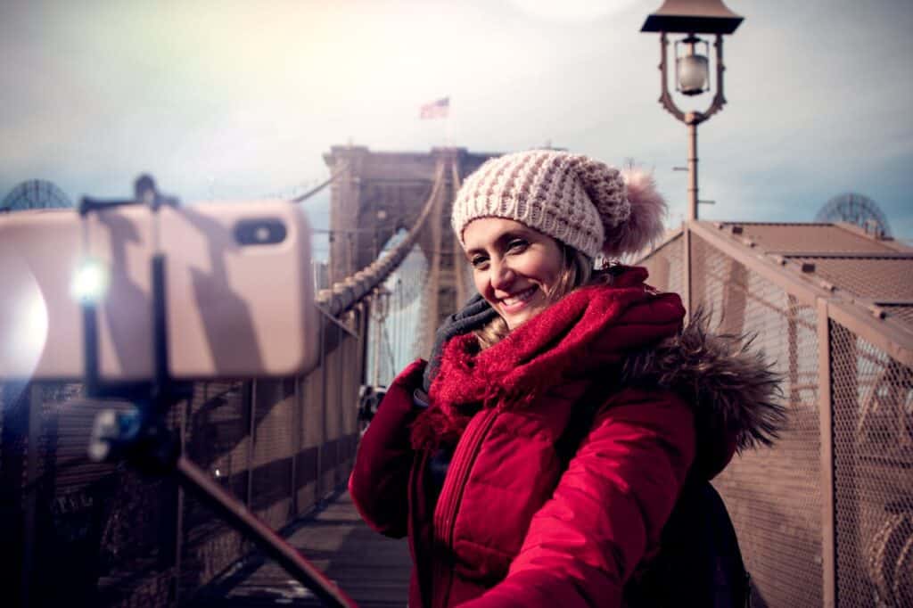 Tourists snapping selfies in front of a famous site