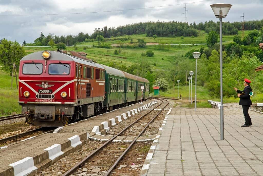 Train moving through scenic countryside.