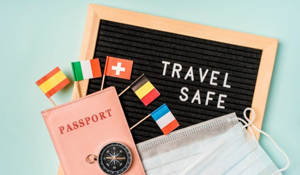 Travel safely concept. Essential travel accessories passports, medical masks.