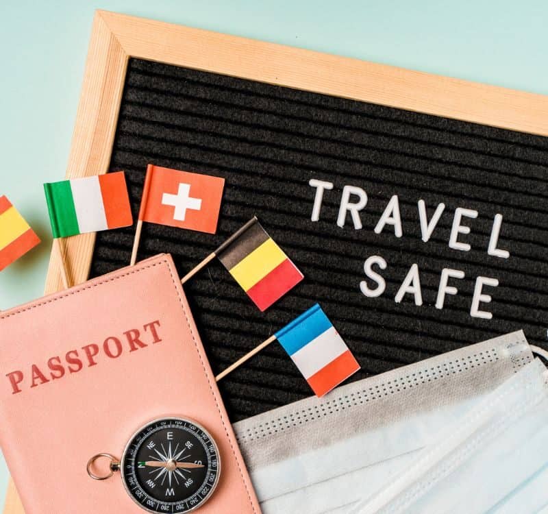 Travel safely concept. Essential travel accessories passports, medical masks.