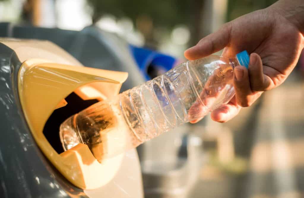 Traveler emptying a reusable water bottle before security
