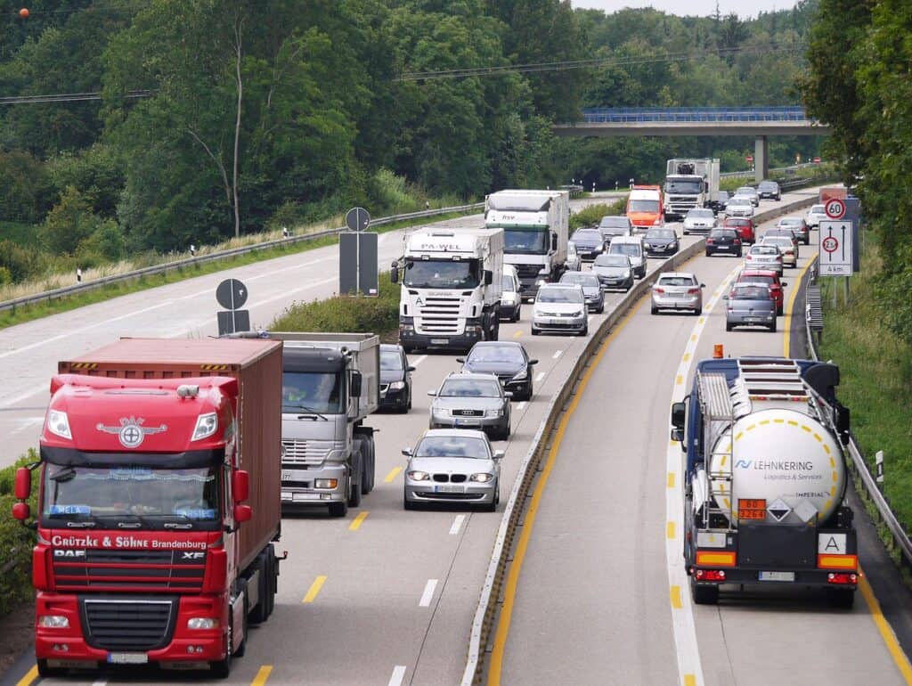 Two lanes blending into one with cars adjusting smoothly