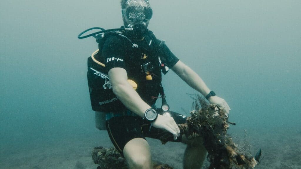 scuba diver photographing shipwreck artifact without touching