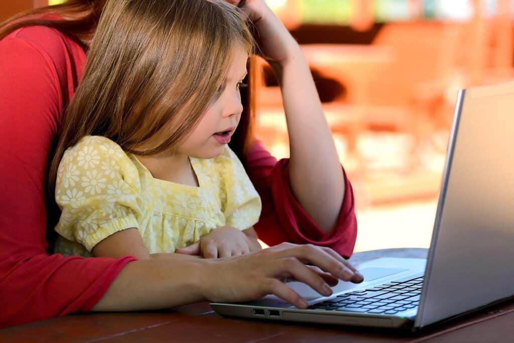 Parents planning camping trip at laptop