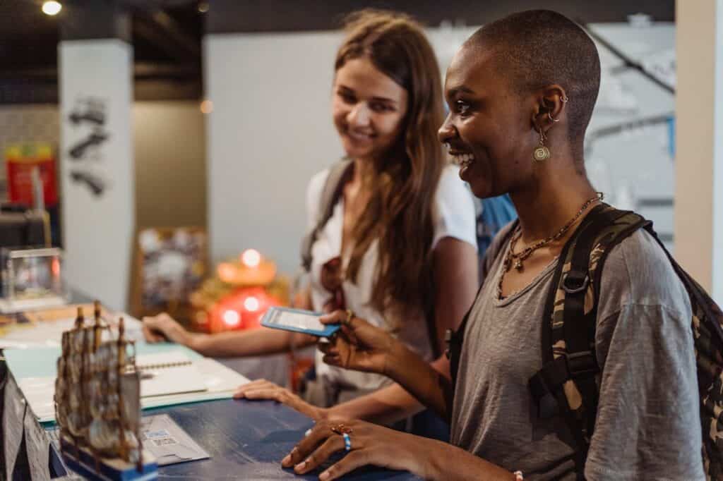 Vibrant, diverse women chatting and smiling in a welcoming, community-oriented setting.