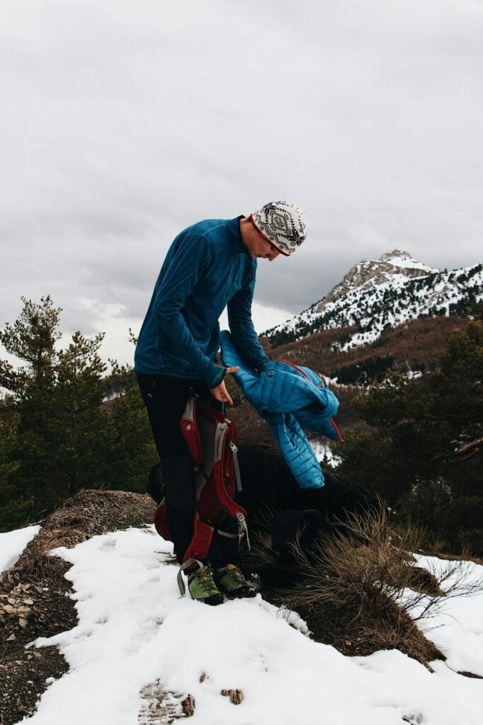 hikers adjusting jackets mid-trail 