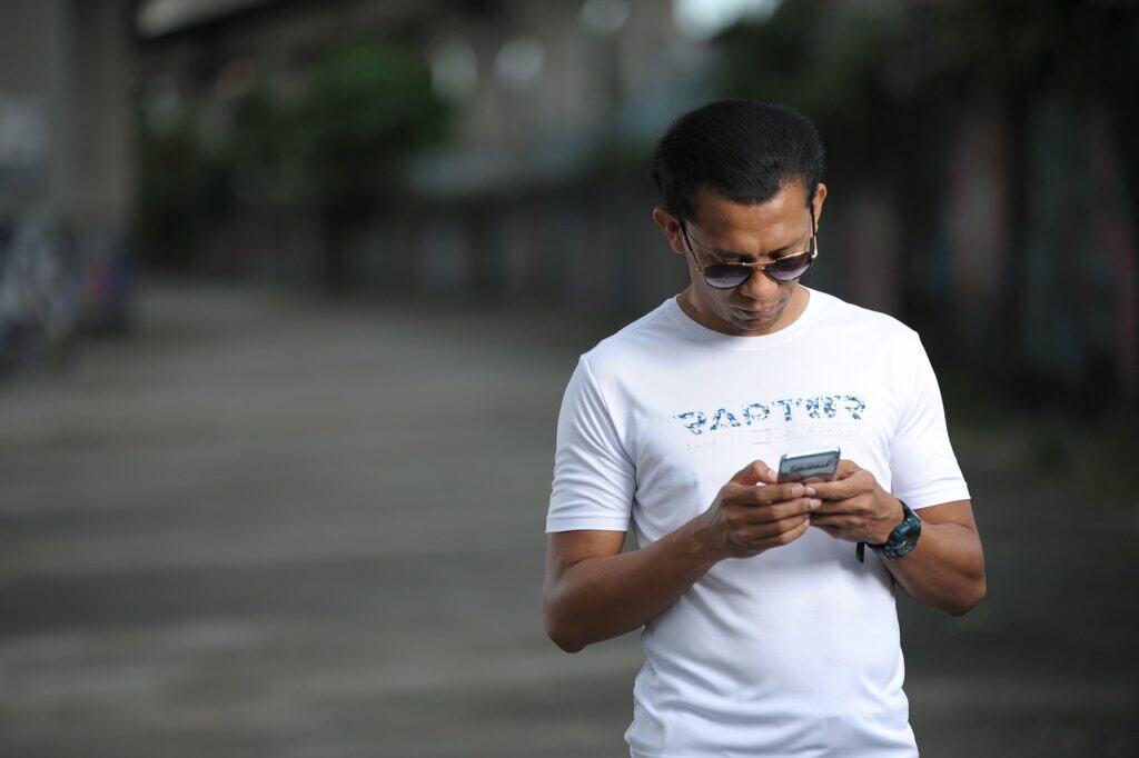 Person using Recreation.gov app on phone outdoors