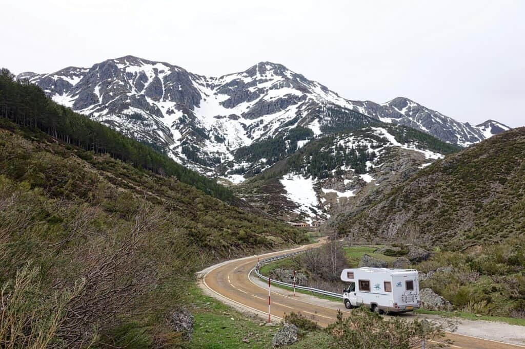 Large RV driving along a winding mountain road
