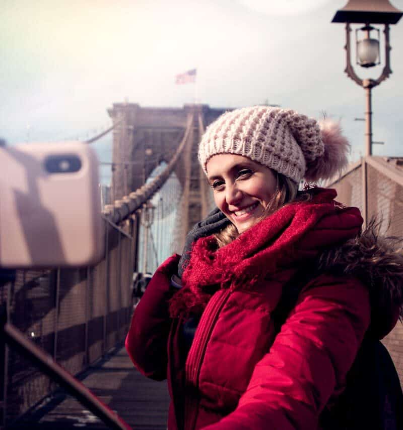 Tourists snapping selfies in front of a famous site