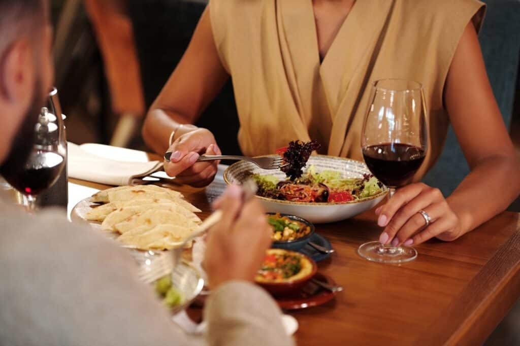 Shows plated small-course dishes in a fine dining setting
