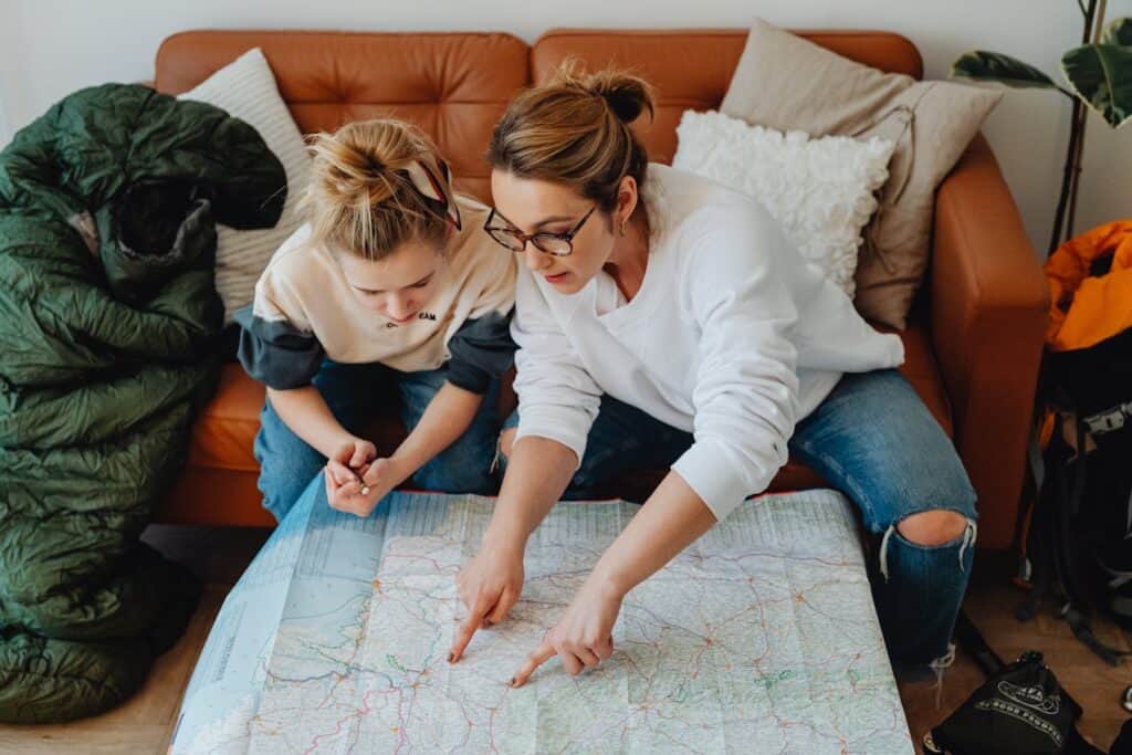 Family pointing at map with campground options marked