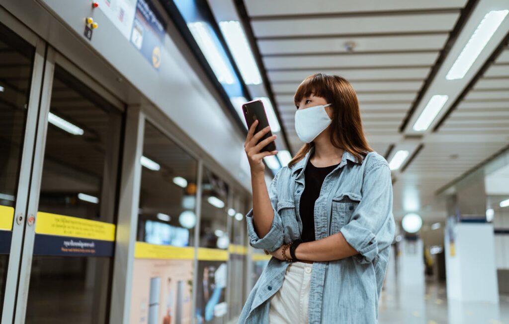 Person talking on speakerphone in subway