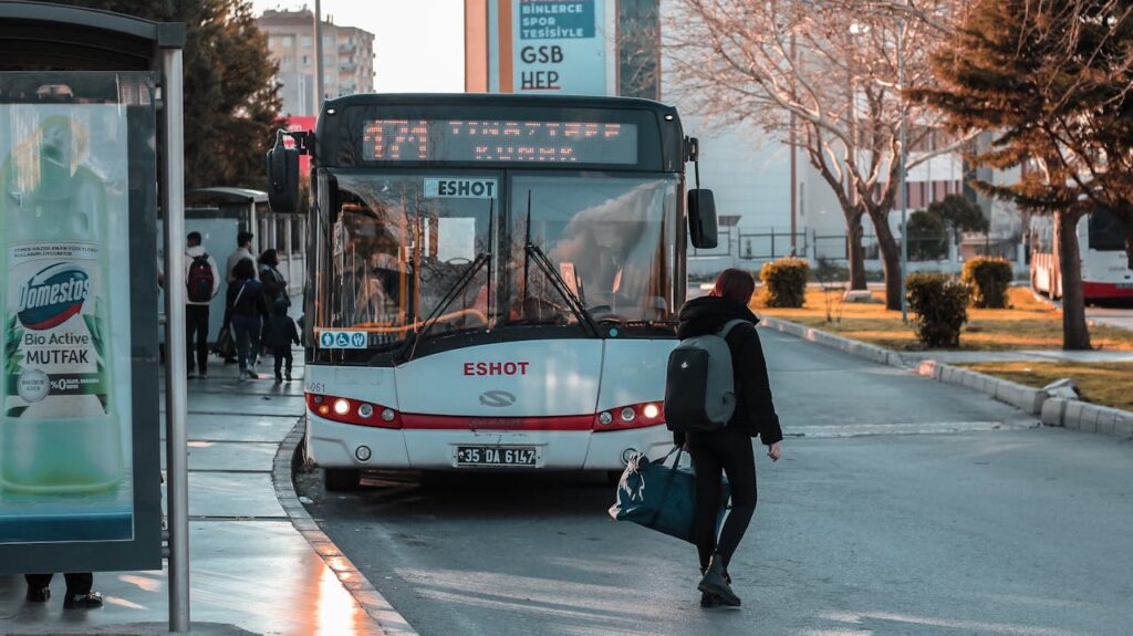traveler boarding city bus with backpack