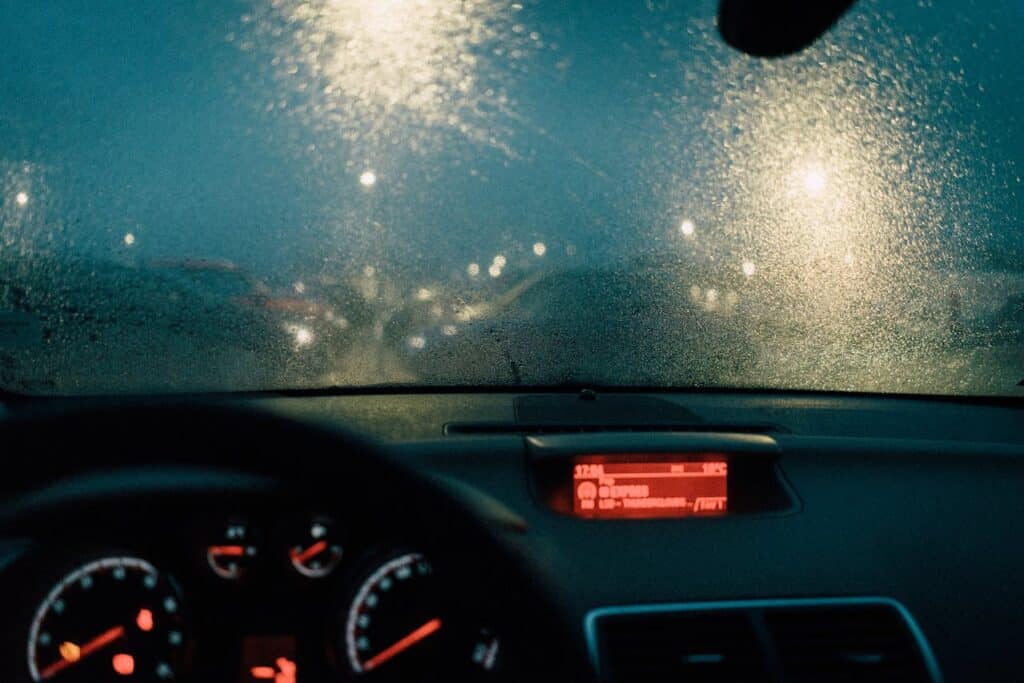 Foggy morning road where headlights barely cut through