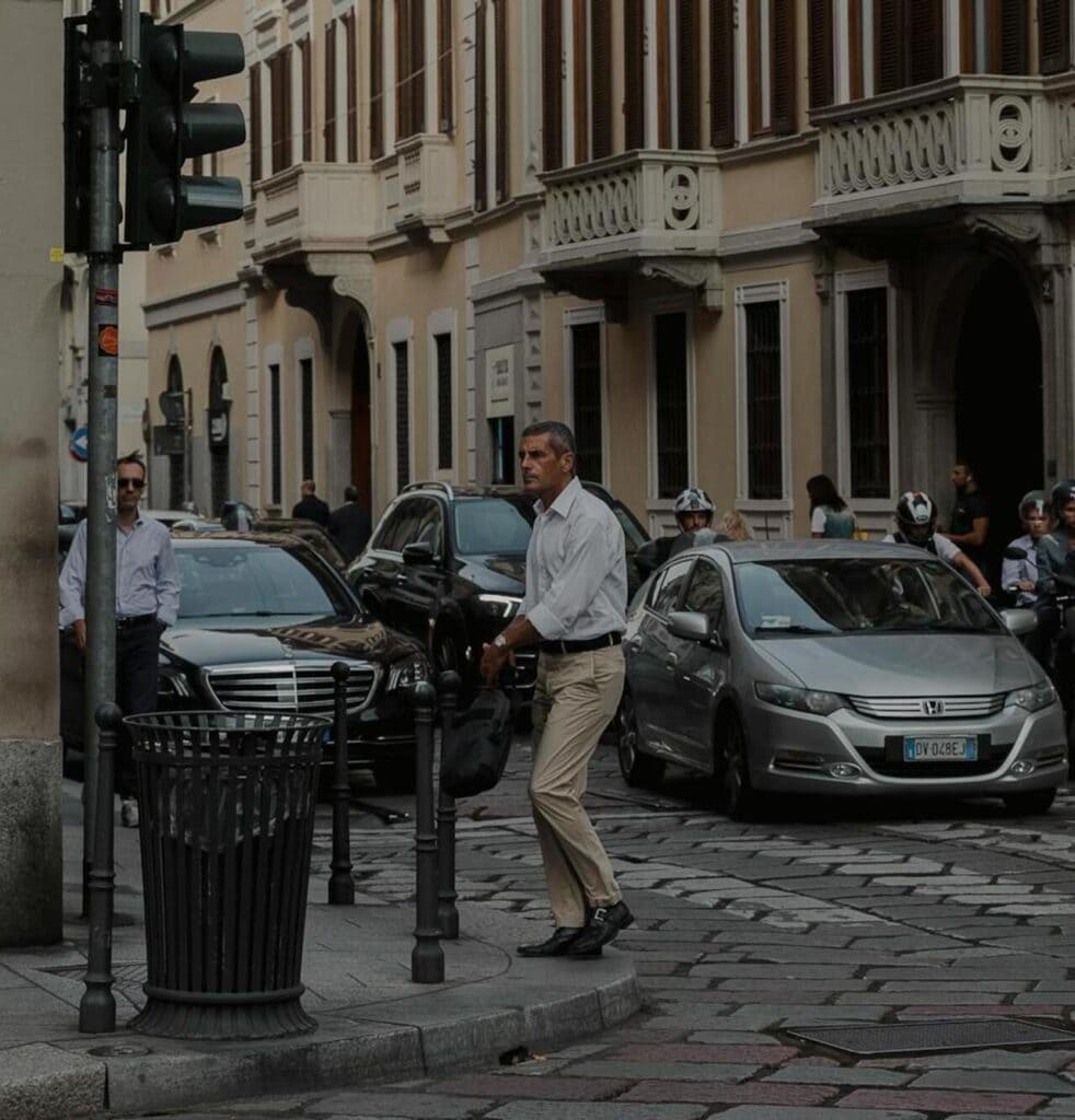 A car and a motorcycle both waiting at a red light signal