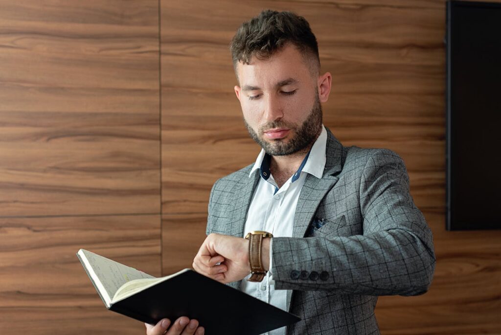 Person checking wristwatch before meeting