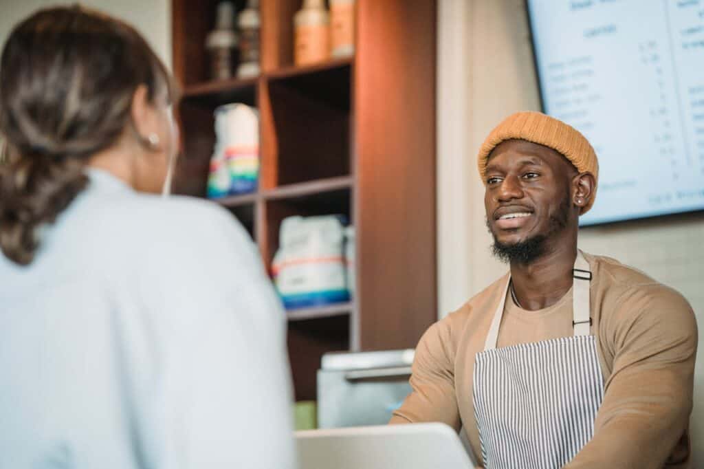ccustomer smiling at waiter in restaurant