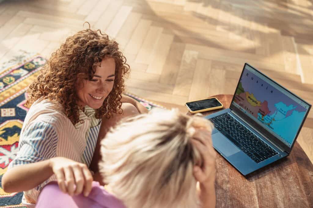 “Family planning vacation on laptop with map 
