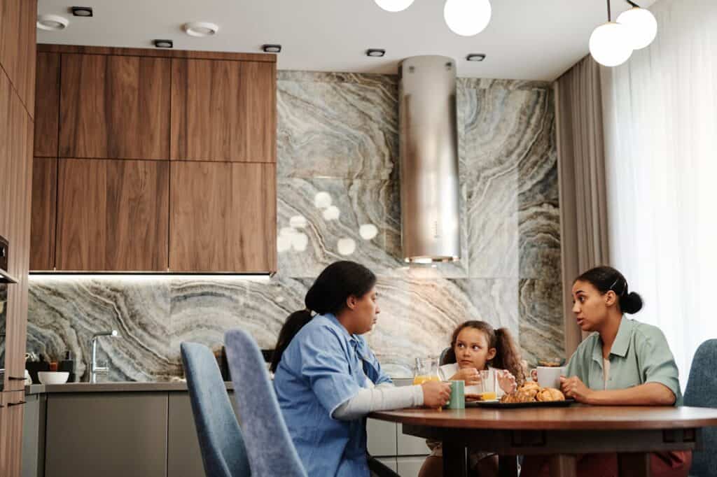 Family at breakfast table with phone and coffee