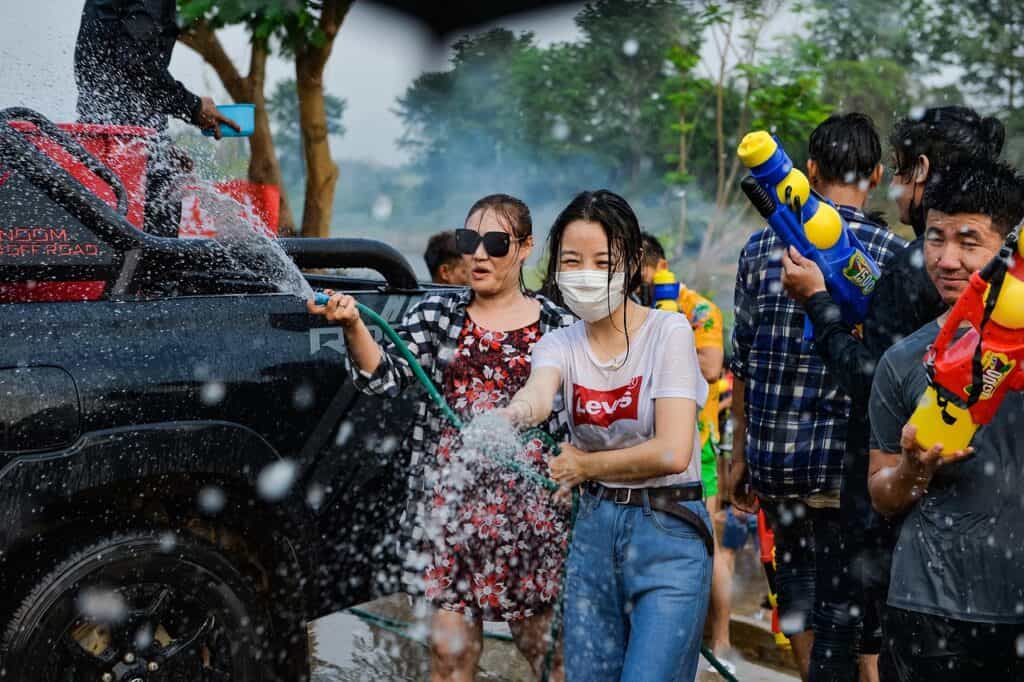 Songkran Thailand people splashing water street festival celebration