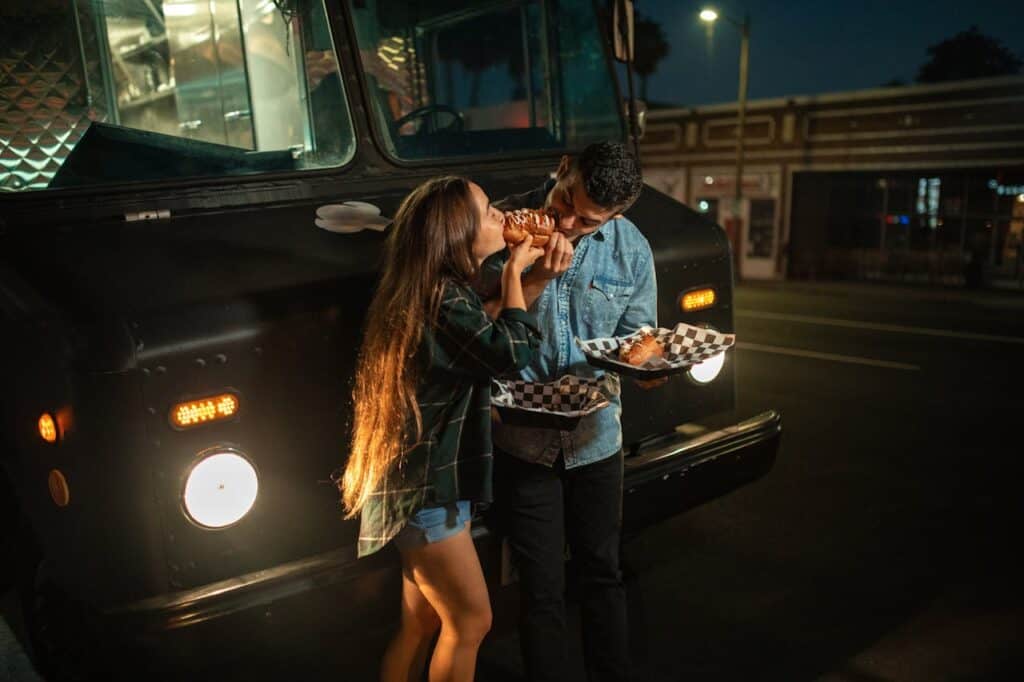 travellers eating food on roadside food truck