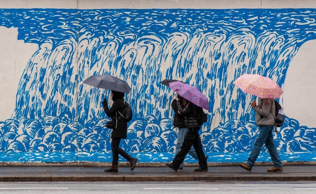 Pilsen mural with locals walking by