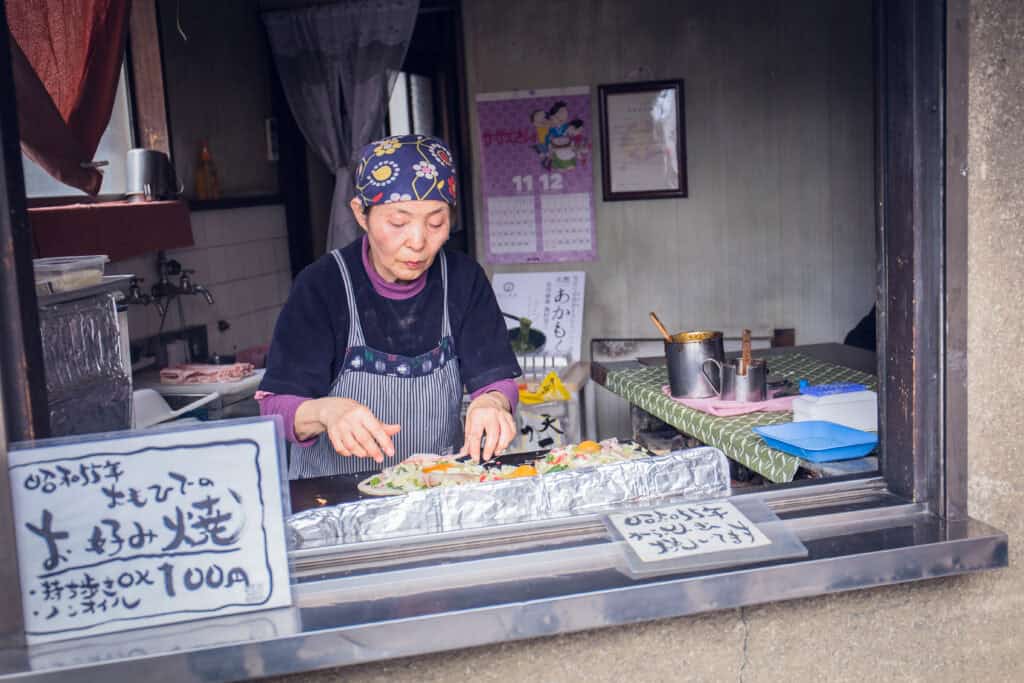 randmother cooking food  at Imadegawa street, Kyoto, Japan.