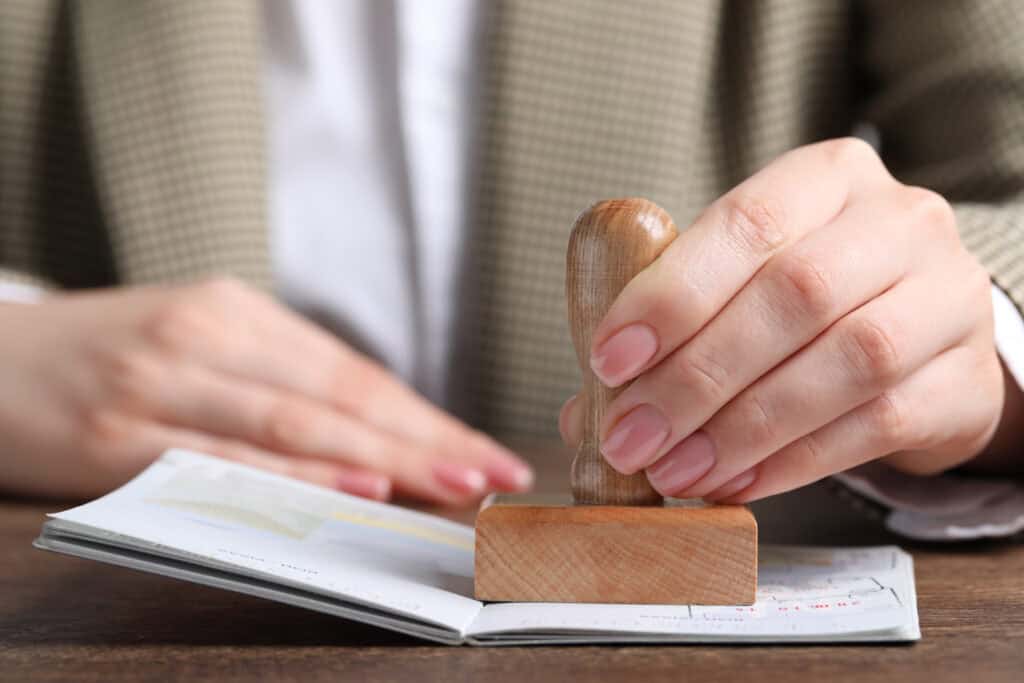 immigration officer stamping passport close-up