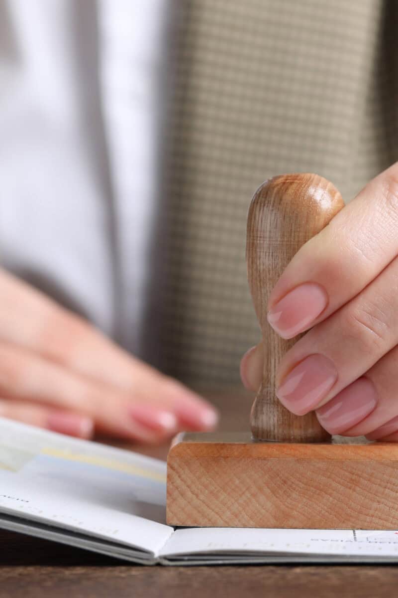 immigration officer stamping passport close-up