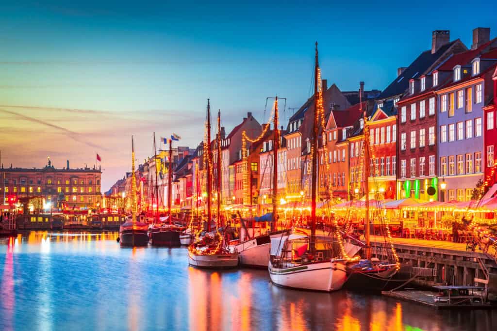 Copenhagen, Denmark. Charm of Nyhavn iconic canal, colorful evening twilight, travel scenics.