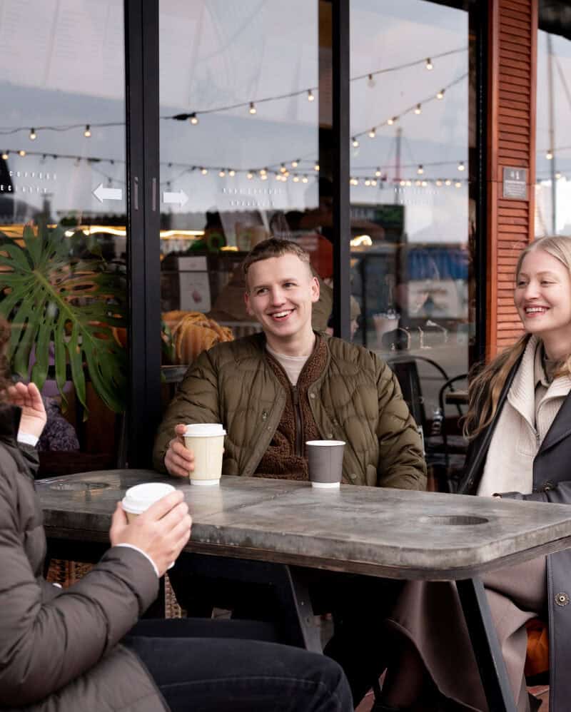 local café winter interior warm lighting rain on window travel atmosphere