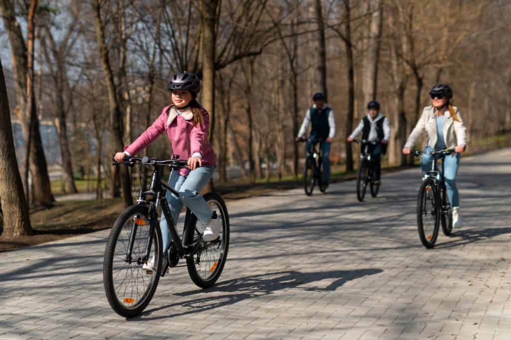 e-bike riders on a tree-lined European boulevard