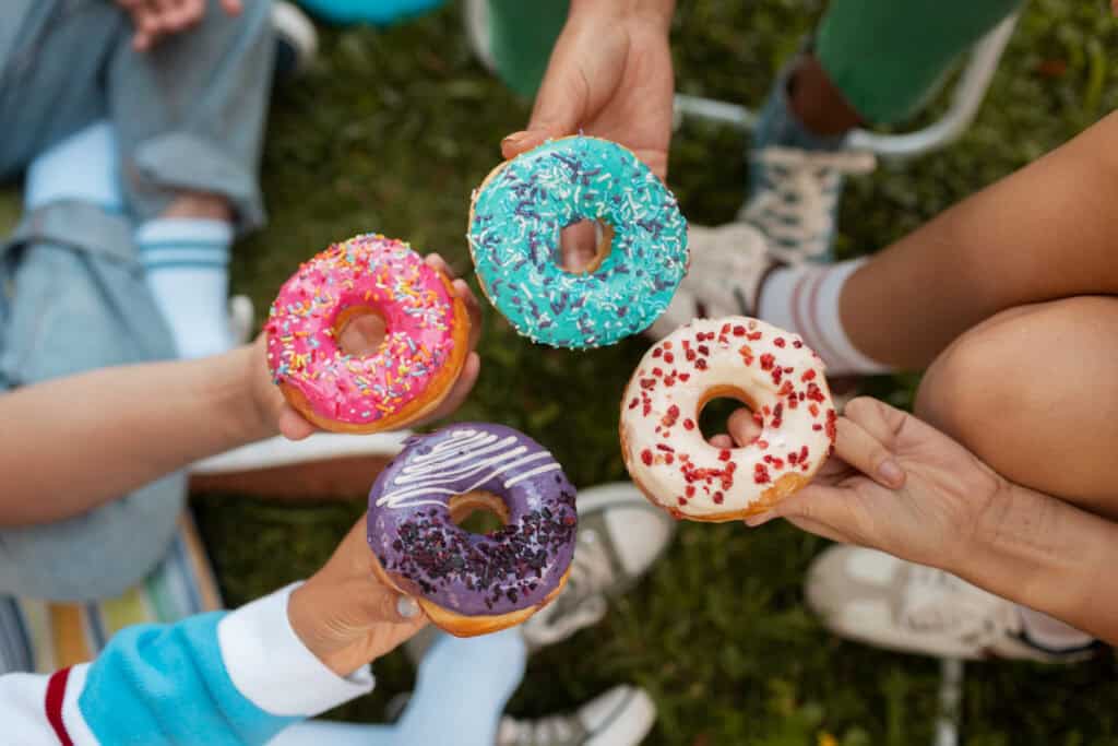 Close-up of hands holding donuts