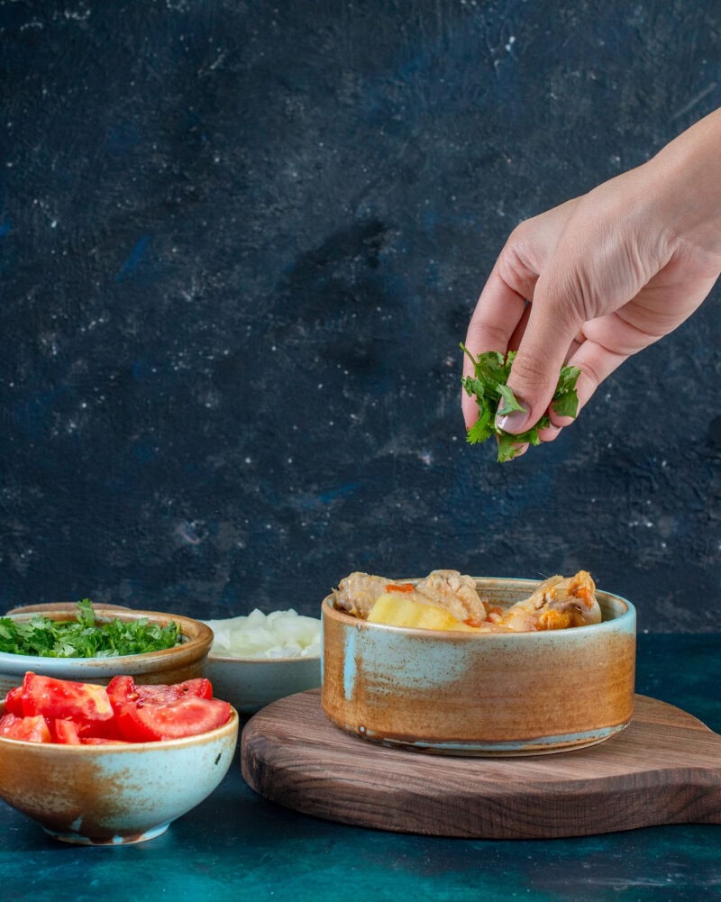 Hands preparing or serving dishes with cultural significance