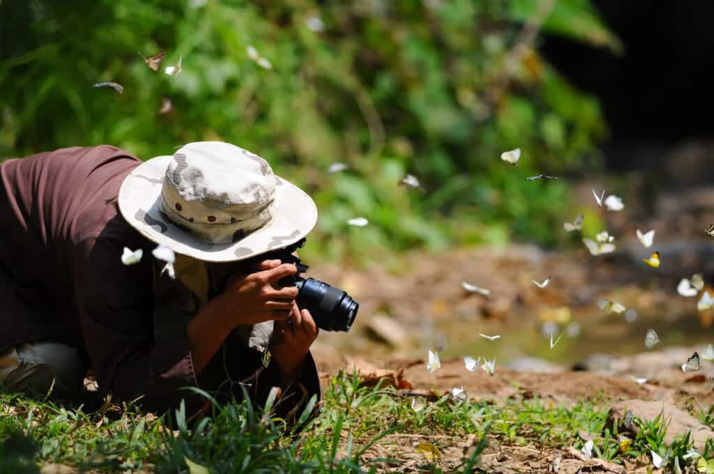 Young photographer taking pictures with digital camera