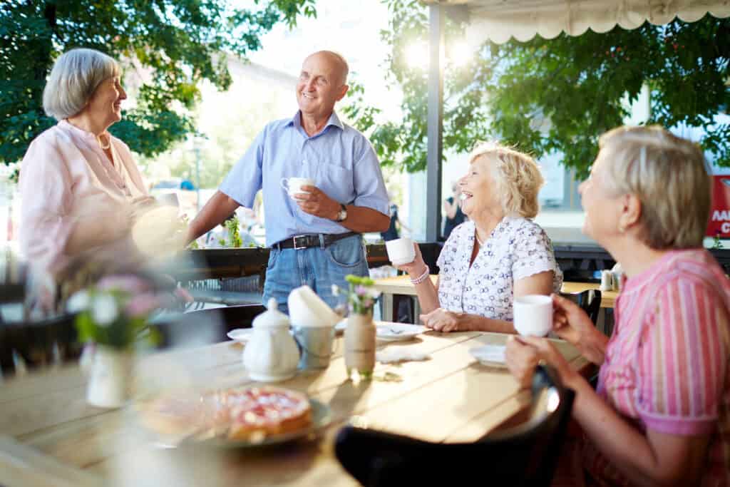 Older adults enjoying coffee at outdoor café in American town