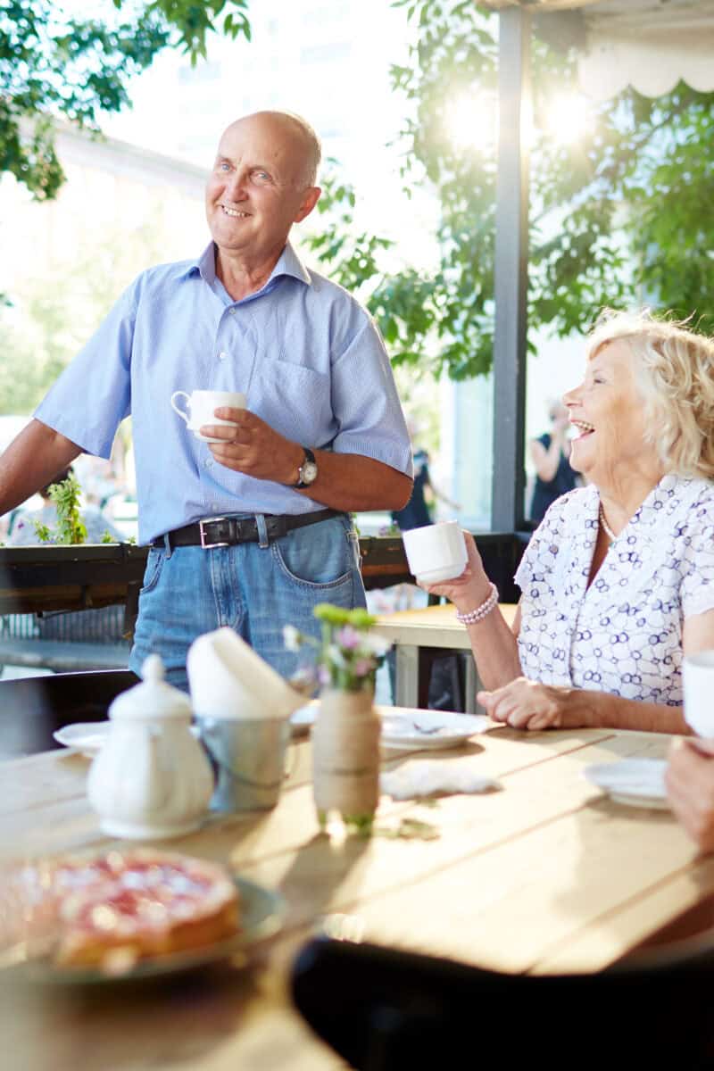Older adults enjoying coffee at outdoor café in American town