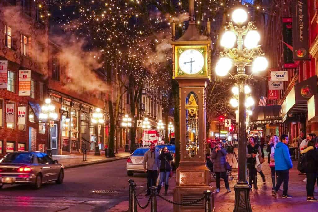 Vibrant mid-size city street with holiday lights and local crowds enjoying the season.
