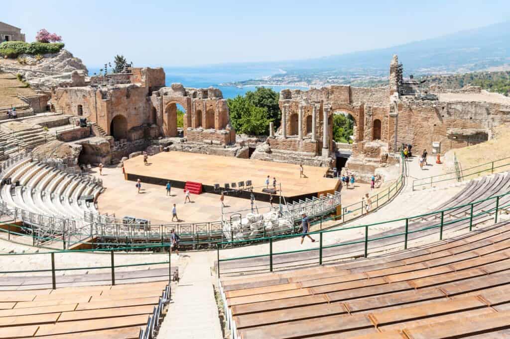 people in Teatro antico di Taormina, ancient Greek Theater (Teatro Greco) in Taormina city in summer day. The amphitheater was built in the third century BC