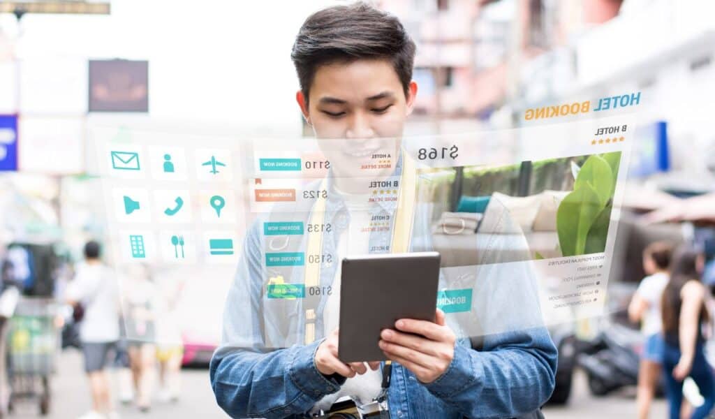 Asian tourist backpacker using mobile appication technology booking hotel online while traveling on vacations, selective focus