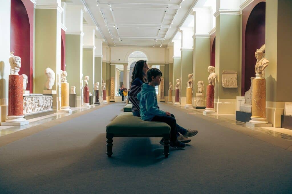 Visitors talking quietly inside a museum to respect shared space.