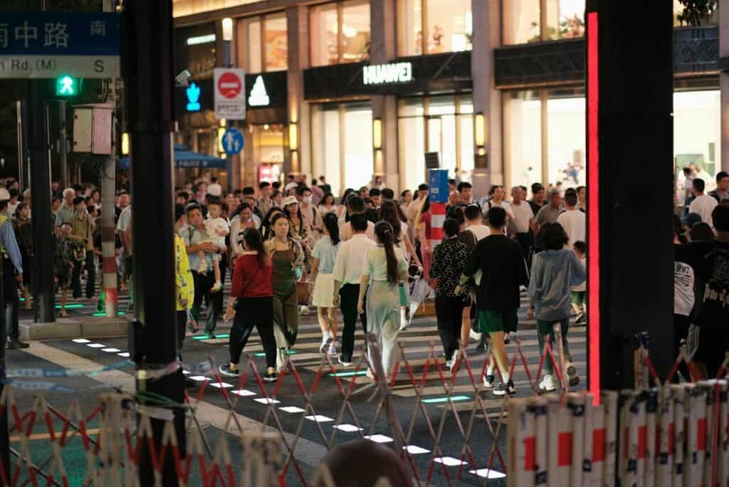 Crowded city sidewalk or escalator with people moving efficiently.