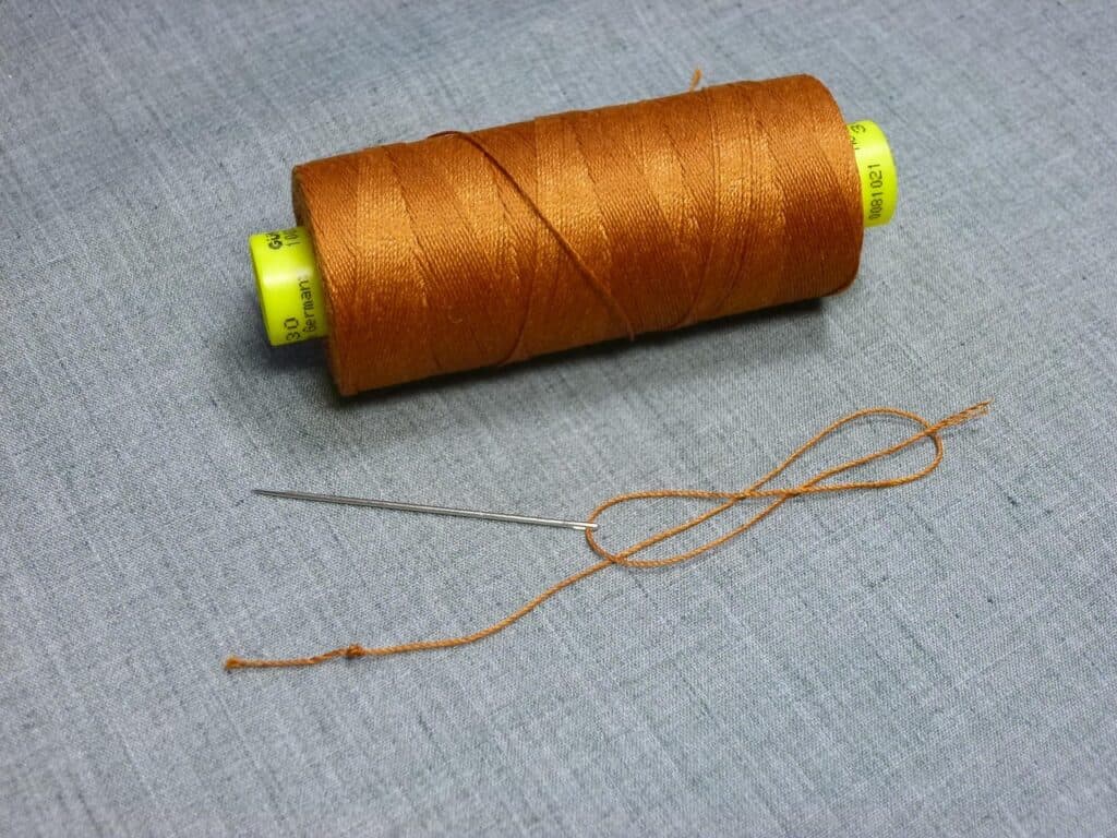 backpack repair with sail needle and waxed thread