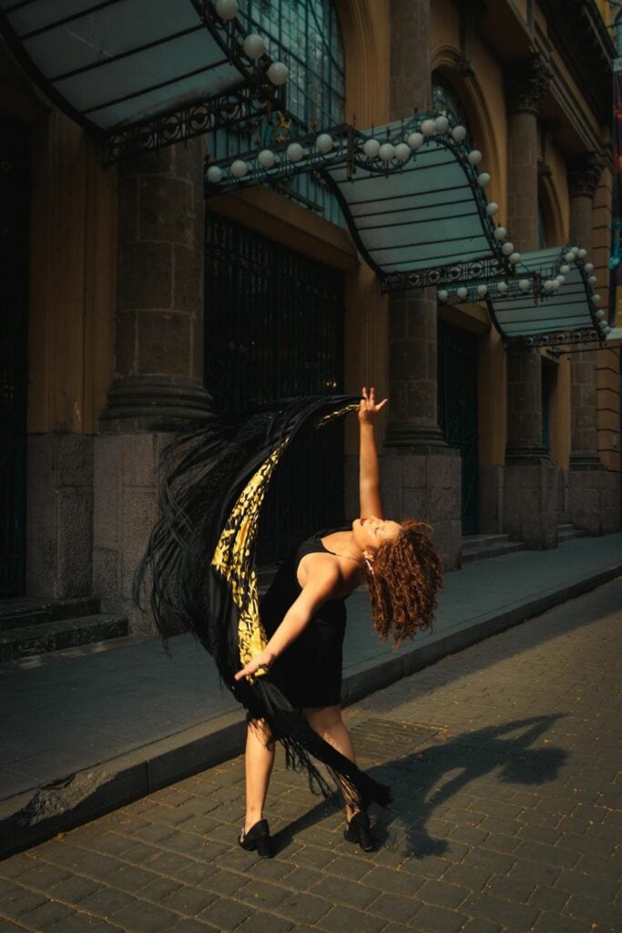 Woman Dancing in Black Dress and Veil on Street