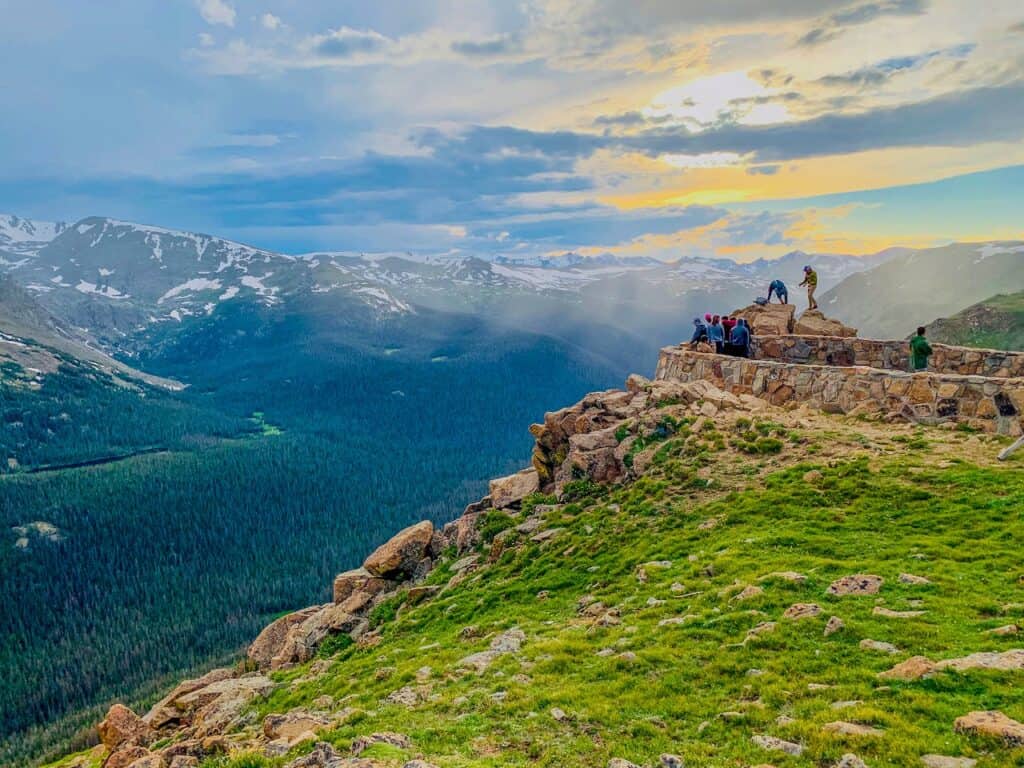 hiker overlooking valley from ridge