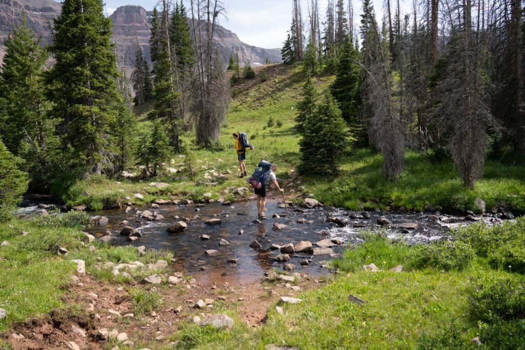 hiker crossing river