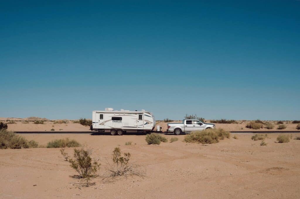 Pickup truck pulling an oversized RV trailer.