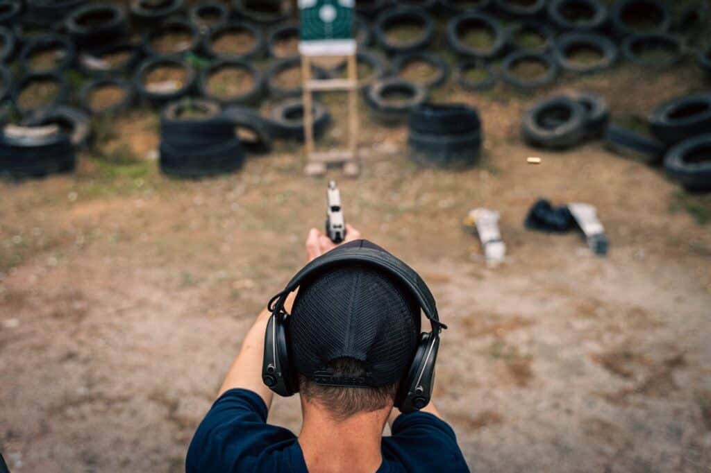 Shooter at a range with finger clearly off the trigger.